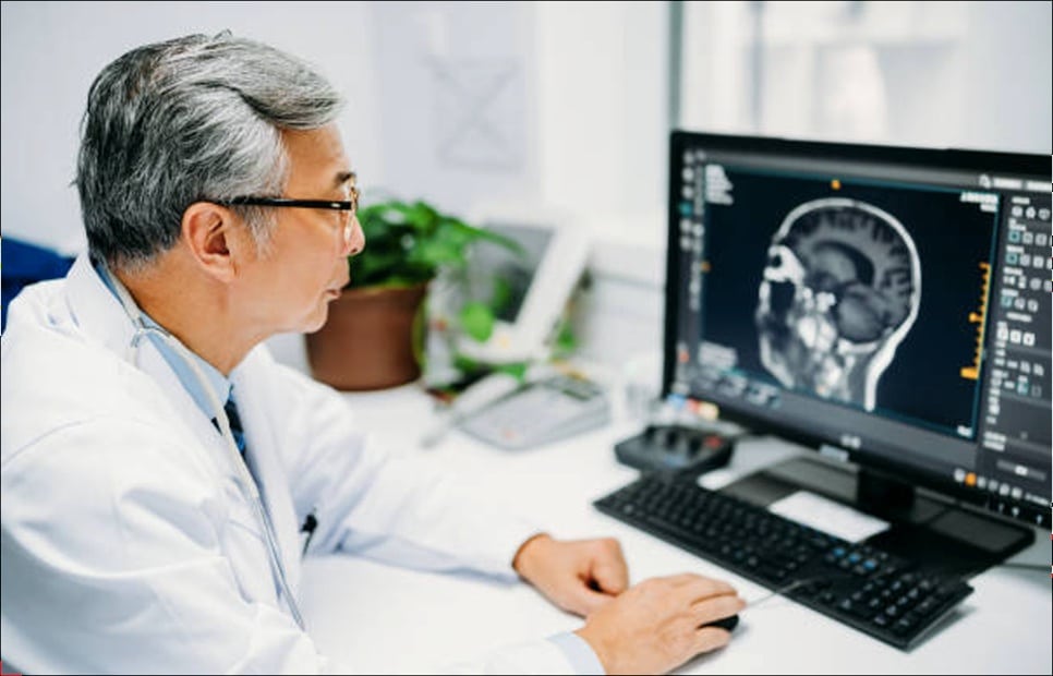 Doctor reviewing radiological scans on a secure computer monitor